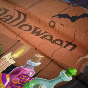 Close-up of Halloween tapestry fabric texture showing purple potions and bat prints