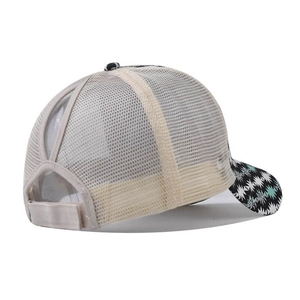 Detail of criss-cross ponytail hole and adjustable strap on geometric print baseball cap