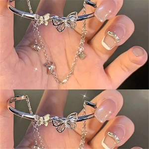 Detail view of silver butterfly bracelet with double layer chain and heart charm