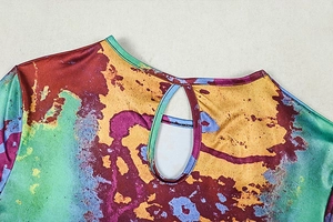 Detail of round neckline with teardrop back cutout on a colorful abstract print dress
