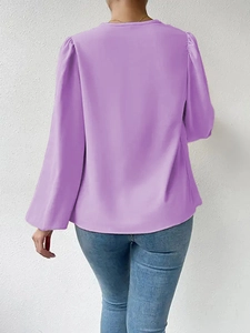 Detail view of lilac long sleeve blouse back featuring puff sleeves and draped fabric