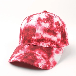 Detailed view of red and white tie-dye patterns on a cotton canvas 6-panel baseball cap