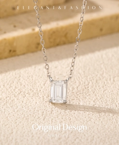 Detailed macro view of an emerald-cut moissanite pendant on a silver-toned chain