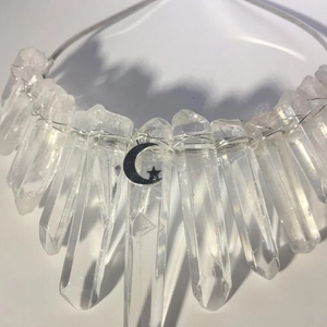 Detail of clear raw crystals hand-wrapped with silver wire and moon star pendants