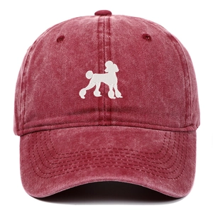 Macro view of white poodle embroidery on washed dark red cotton baseball cap