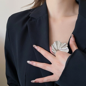 Detailed macro view of silver brushed metal ring with pleated ginkgo leaf design
