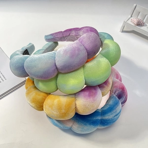 Set of four colorful tie-dye velvet sponge headbands with a stylish thick padded design