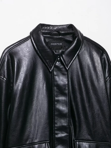 Close-up of the vintage faux leather aviator jacket lapel with detailed stitching and texture