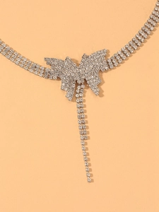 Detail of silver butterfly choker necklace with shimmering rhinestones and tassels
