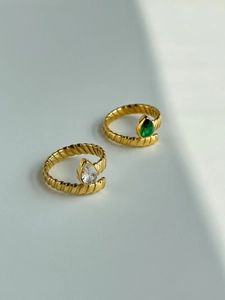 Detail of 18k gold plated spiral rings featuring pear-cut white and green zircon stones
