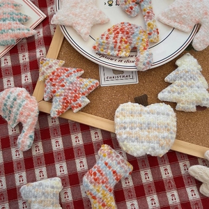 Close-up of knit Christmas tree and stocking patches for festive DIY sewing projects