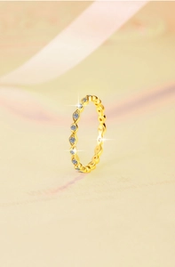 Close-up of golden S925 silver ring band set with sparkling micro-pave cubic zirconia