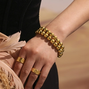 Minimalist double-layered gold bead bracelet and textured rings set for women