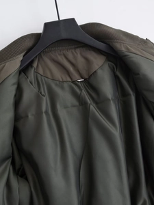 Detailed view of the olive green bomber jacket smooth lining and inner collar finish