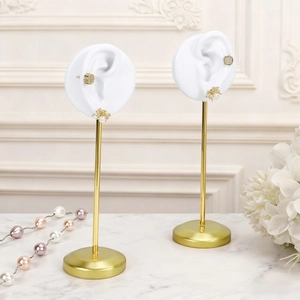 Dual earring display stand with green resin base and realistic silicone ear model
