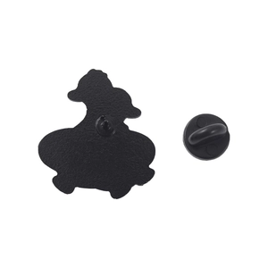 Black enamel cartoon duck badge with butterfly clutch back on white background