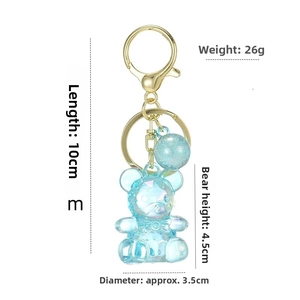 Blue acrylic bear keychain with gold clasp, 10cm total length and 3.5cm glitter ball detail