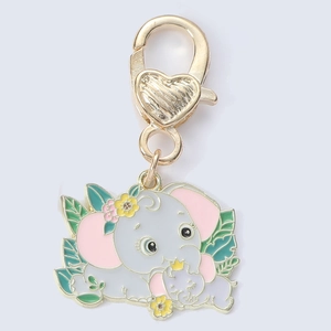 Close-up of a cute gray enamel elephant keychain with flowers and a gold heart clasp