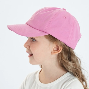 Close-up of bright pink cotton baseball cap on child showing curved brim and texture