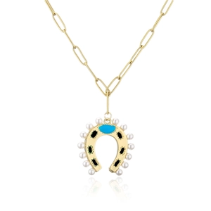 Close-up of golden horseshoe pendant with pearls, black enamel, and blue gemstone detail