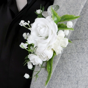 Elegant white artificial rose boutonniere with lily of the valley on a grey suit lapel
