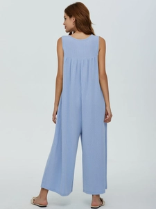Detail of light blue sleeveless jumpsuit with vertical ribbed texture and wide-leg design