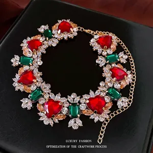 Luxury choker set with red heart zircon and green emerald stones on gold plated base