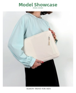 Detail of minimalist cream laptop sleeve showing waterproof fabric and front zipper pocket