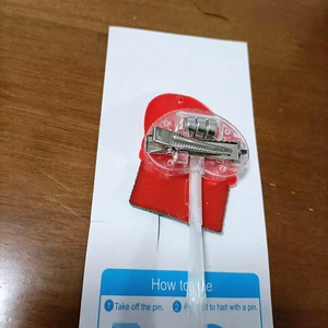 Close-up of LED glowing hair braid back with battery compartment and English instructions