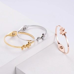 Three-color butterfly titanium steel bangles in gold, silver, and rose gold finishes