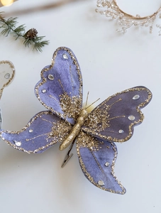Detailed view of purple fabric butterfly clip with gold glitter and sparkling rhinestones