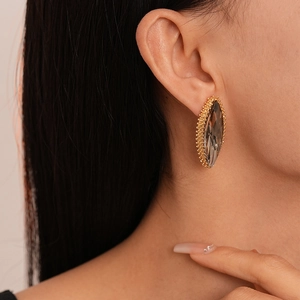 Close-up of elegant marquise-cut grey crystal earring with gold micro-bead setting