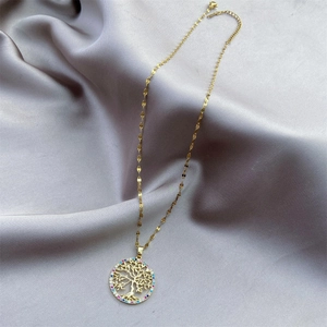 Detailed macro view of golden Tree of Life pendant with colorful cubic zirconia stones