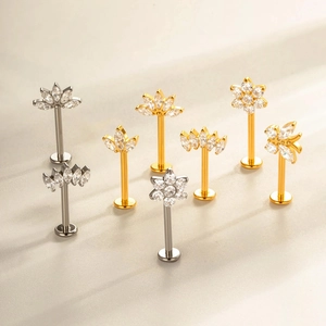 G23 titanium stud earrings set with crystal flower and leaf designs in gold and silver