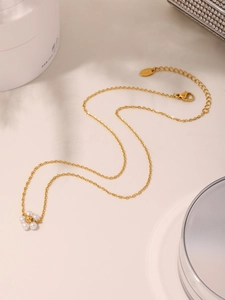 Detail of 18K gold-plated stainless steel necklace with delicate shell pearl flower pendant