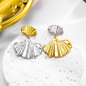 Exaggerated ginkgo leaf stud earrings in two-tone gold and silver metallic finish