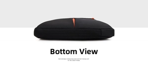 Detailed bottom view of laptop sleeve showing black fabric texture and orange zipper accent