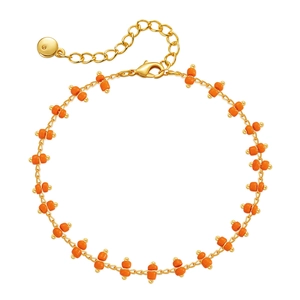 Detail of bohemian gold chain bracelet with orange beads and adjustable lobster clasp