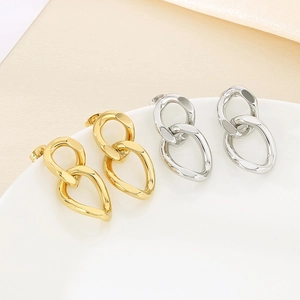 Macro shot of gold and silver interlocking chain link earrings with S925 engraved stamp