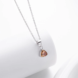 Detail shot of a silver S925 necklace with a champagne triangle gemstone pendant