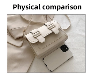 Cream white crossbody bag next to a smartphone showing size scale and leather texture