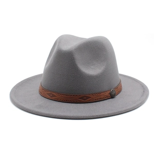Close-up of grey wool fedora hat with brown leather band and vintage metal buckle detail
