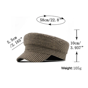 Detail view of houndstooth newsboy cap showing dimensions and fabric texture details