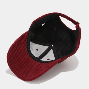Interior view of corduroy baseball cap in burgundy with adjustable strap and stitching detail
