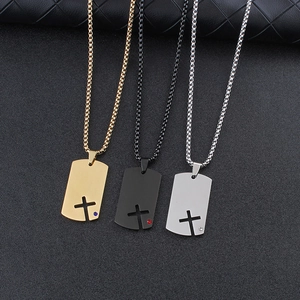 Close-up of cross necklaces in gold, black, and silver finish with small gemstones