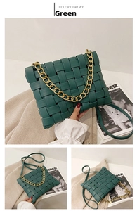 Detail view of woven dark green crossbody bag with thick metal chain and leather texture