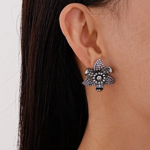 Vintage luxury flower earrings with purple and white cubic zirconia in black plating