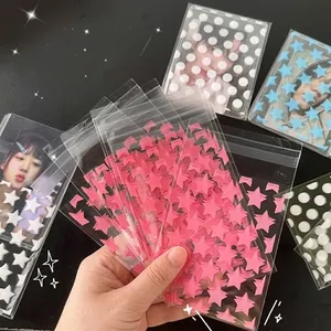 Detail view of transparent self-adhesive sleeves with star and dot patterns for photocards