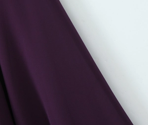 Detailed macro view of the dark purple chiffon fabric texture for this elegant dress