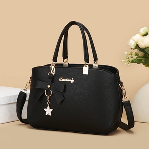 Elegant black lychee texture handbag with bow detail and star pendant for women
